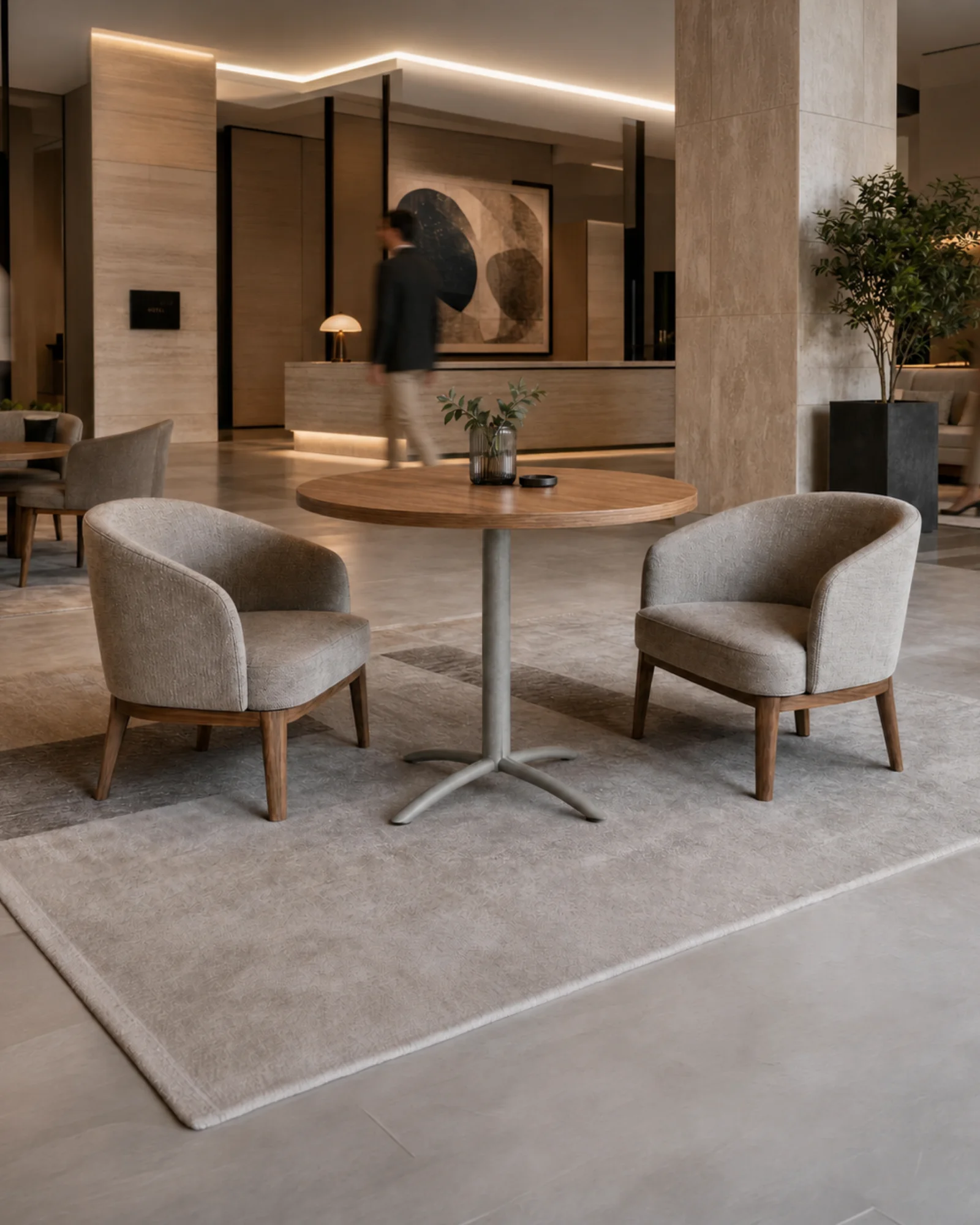 Round TableX pedestal table with two lounge chairs in a hotel lobby