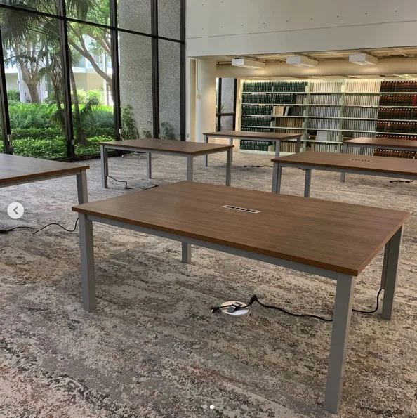 Table leg with power cords routed down a wire management channel