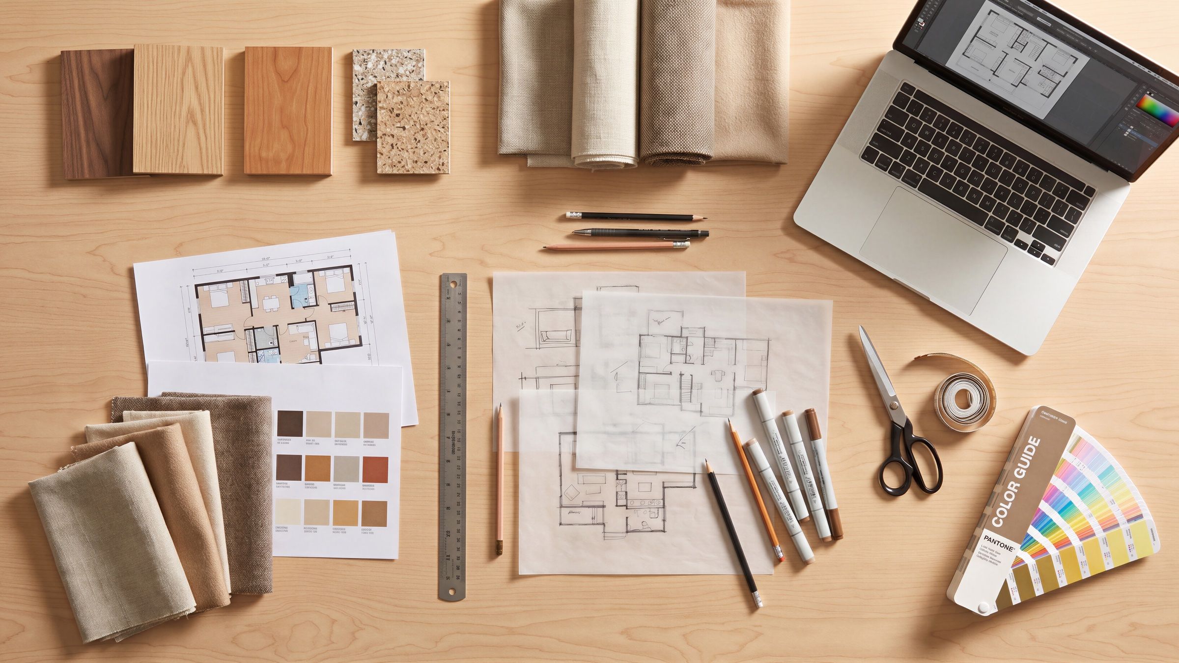 Finish samples, drawings, and tools on a designer's desk